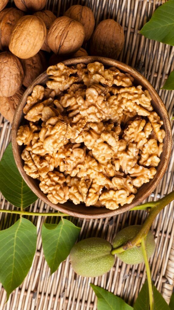Light golden-brown walnut halves arranged on a wooden surface